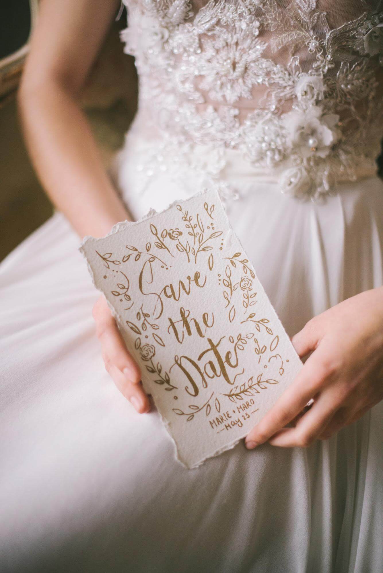 bride with save the date invitation
