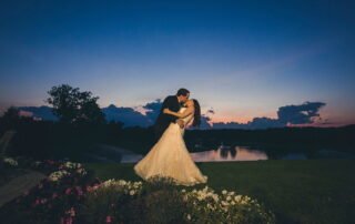 Stunning photo of a bridal couple kissing at sunset at Brooklake Events in Florham Park, NJ