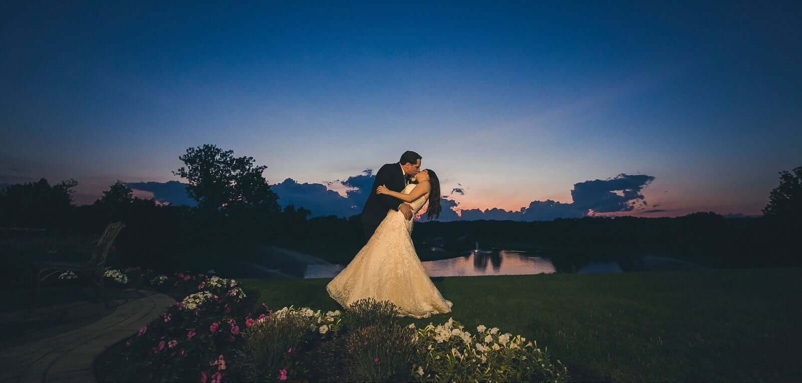 Stunning photo of a bridal couple kissing at sunset at Brooklake Events in Florham Park, NJ