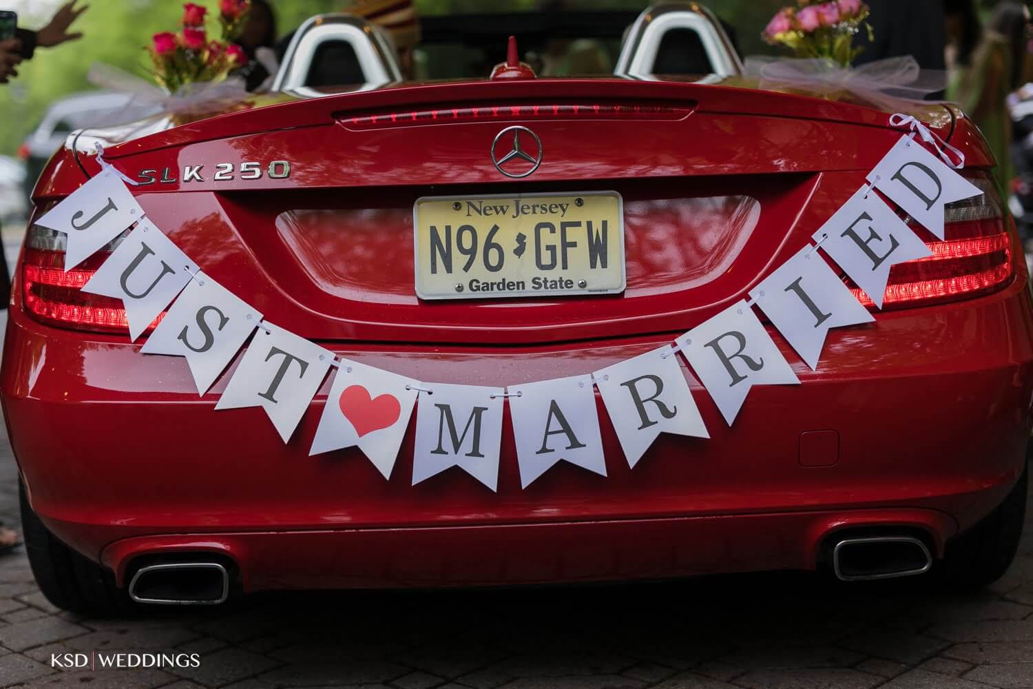 Close up of the Just Married sign tied onto the trunk of a red car at Brooklake Events in NJ