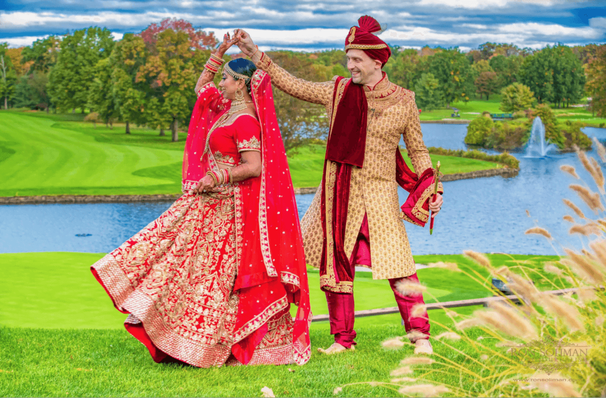 An Indian bride and groom gracefully dancing in front of a picturesque golf course at one of the gorgeous outdoor wedding venues in NJ.