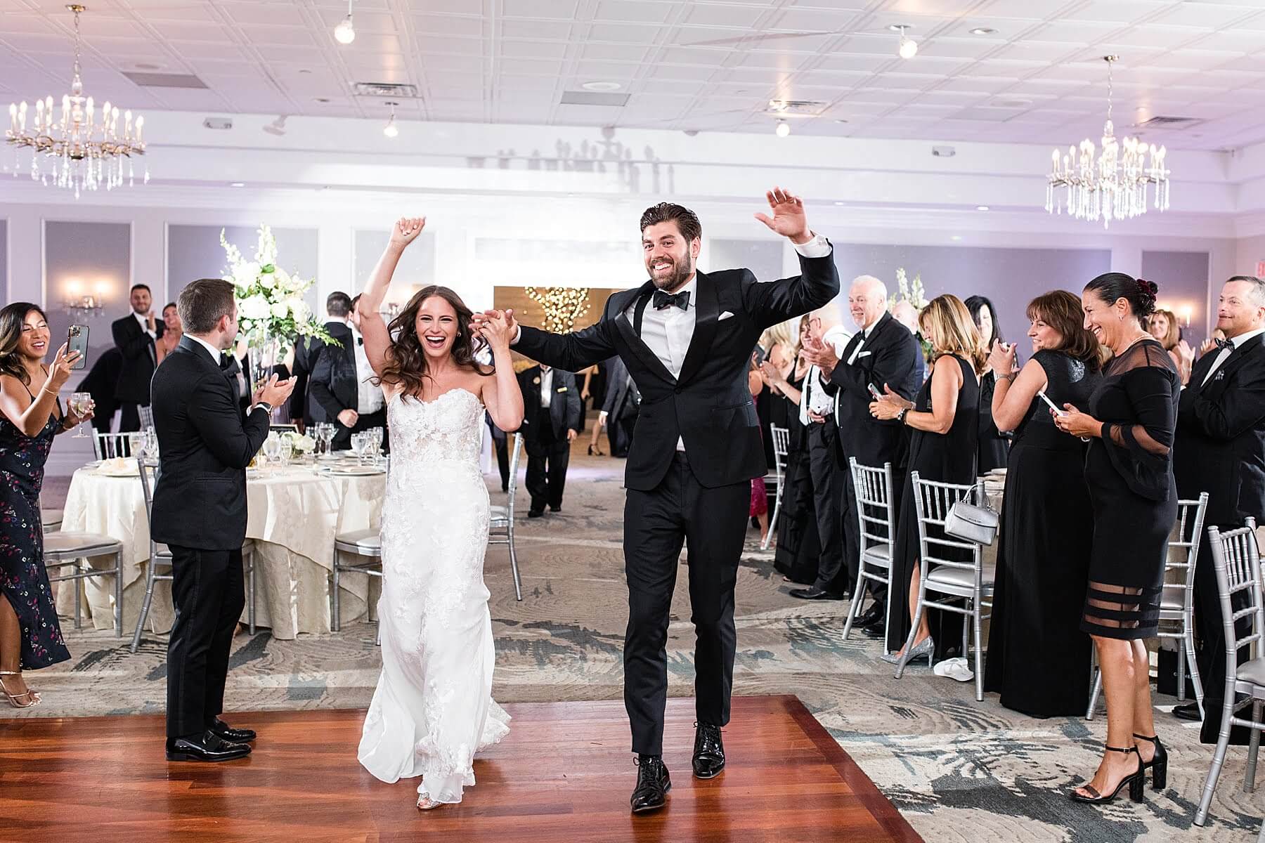 A newly married couple walks down the aisle at their New Jersey wedding reception.