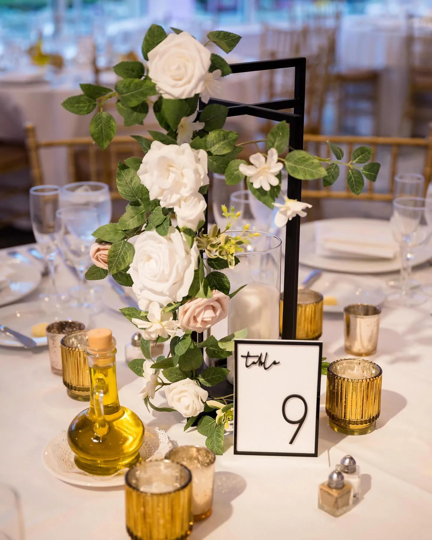 Elegant table setting with floral centerpiece and table number at a kosher wedding in NJ.